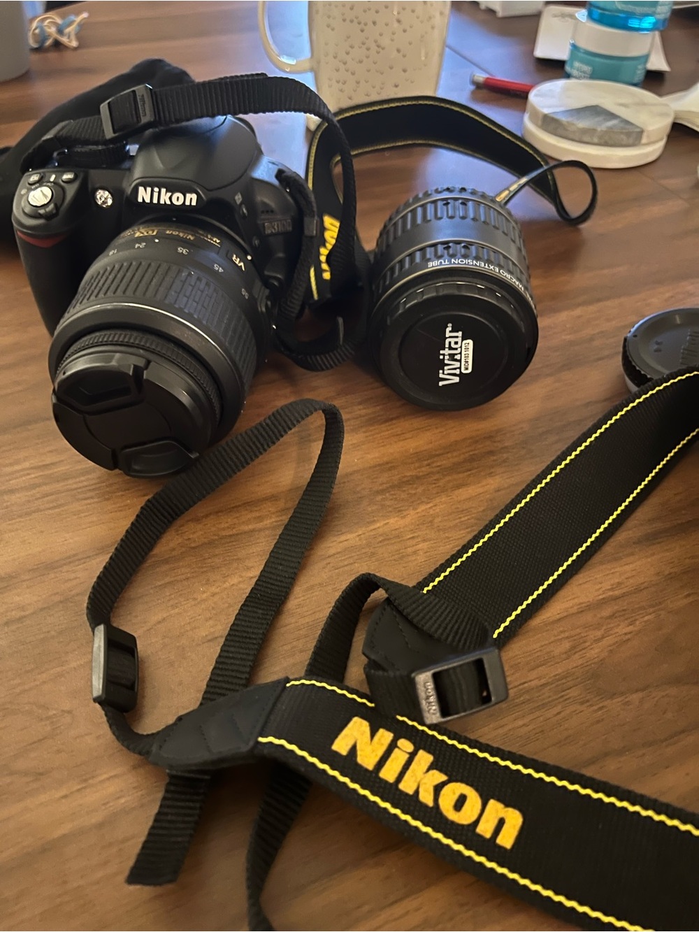 Nikon Black DSLR 3100 with Black and Yellow Nikon Strap and Extra Lens